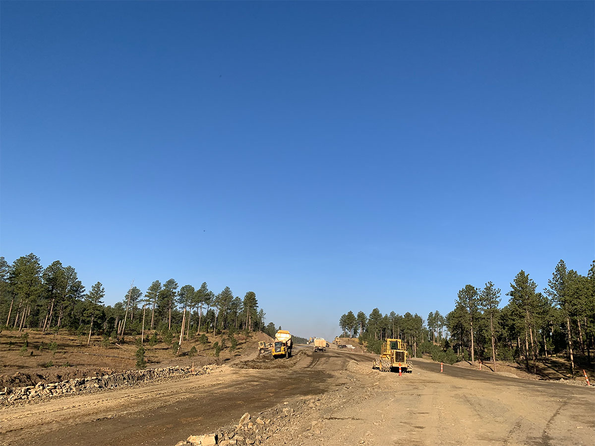 Machinery grading the roadway.